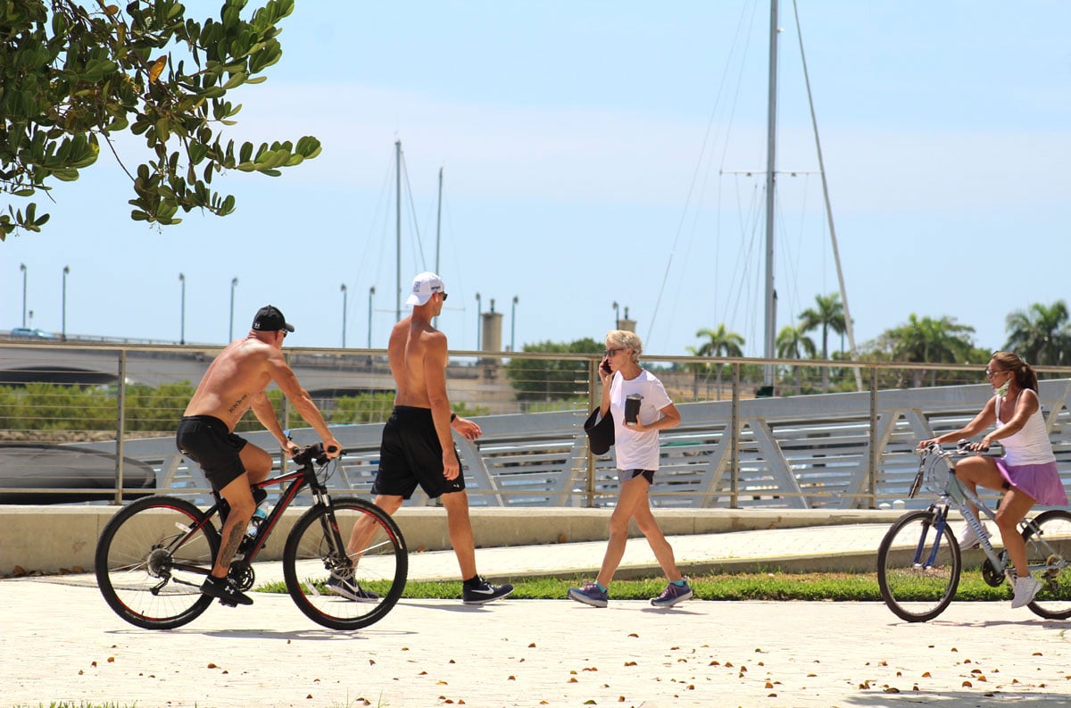 Jogger, Cyclist, and Walker Crossing Paths on Flager Pedestrian Pathway in Downtown West Palm Beach, FL
